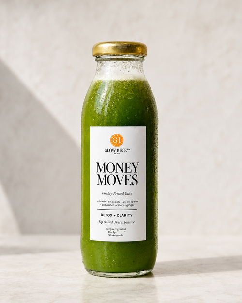 A glass bottle of  Money Moves Freshly cold pressed Juice set against a neutral light gray background.
