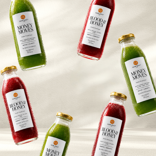 Six glass bottles of Glow Juice  juices arranged diagonally on a light beige background.